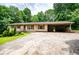 Charming ranch-style home with a covered carport and a spacious front yard at 100 Eldorado Dr, Carrollton, GA 30116