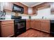 A modern kitchen with wooden cabinetry and sleek, black appliances at 100 Eldorado Dr, Carrollton, GA 30116