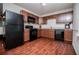 A modern kitchen with wooden cabinetry and sleek, black appliances at 100 Eldorado Dr, Carrollton, GA 30116