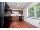 A modern kitchen with wooden cabinetry and sleek, black appliances at 100 Eldorado Dr, Carrollton, GA 30116
