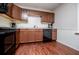A modern kitchen with wooden cabinetry and sleek, black appliances at 100 Eldorado Dr, Carrollton, GA 30116