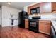 Cozy kitchen with black appliances, tile backsplash and wood-look floors at 100 Eldorado Dr, Carrollton, GA 30116