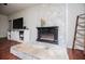 Living room with stone fireplace and entertainment center at 100 Eldorado Dr, Carrollton, GA 30116
