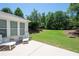 A backyard featuring a concrete patio and a lush lawn, perfect for outdoor relaxation and entertainment at 130 Bevington Ln, Woodstock, GA 30188