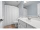 Bathroom featuring a white vanity, updated fixtures, and a shower with tile surround at 130 Bevington Ln, Woodstock, GA 30188
