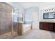 Well-lit bathroom with a glass-enclosed shower, a soaking tub, tile floors, and a modern vanity at 130 Bevington Ln, Woodstock, GA 30188