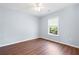 Bedroom with hardwood floors, light blue walls, and a window providing natural light at 130 Bevington Ln, Woodstock, GA 30188