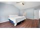 Spacious bedroom with wood floors, a ceiling fan, and access to an ensuite bathroom at 130 Bevington Ln, Woodstock, GA 30188