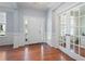 Bright foyer with hardwood floors, wainscoting, and french doors leading to an office space at 130 Bevington Ln, Woodstock, GA 30188