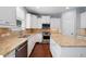 Bright kitchen with white cabinetry, stainless steel appliances, and granite countertops at 130 Bevington Ln, Woodstock, GA 30188