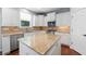 Bright kitchen with white cabinetry, stainless steel appliances, and granite countertops at 130 Bevington Ln, Woodstock, GA 30188