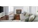 Comfortable living room with a stone fireplace, TV, and view to the yard at 130 Bevington Ln, Woodstock, GA 30188