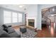 Cozy sunroom with cathedral ceilings, fireplace, and plush seating at 130 Bevington Ln, Woodstock, GA 30188