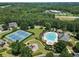 Aerial view of community amenities featuring a swimming pool, playground, tennis courts, and a well-manicured green area at 169 Wallnut Hall Circle, Woodstock, GA 30189