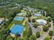 Aerial view of community amenities featuring tennis courts, pickleball courts, a swimming pool, and a playground at 169 Wallnut Hall Circle, Woodstock, GA 30189