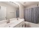 Well-lit bathroom with double vanity sinks and modern fixtures at 169 Wallnut Hall Circle, Woodstock, GA 30189