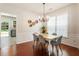 Elegant dining room featuring hardwood floors, neutral walls, and a view to the kitchen at 169 Wallnut Hall Circle, Woodstock, GA 30189