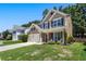 Attractive home with a well-maintained lawn, two-car garage and inviting front porch seating at 169 Wallnut Hall Circle, Woodstock, GA 30189