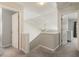 Upstairs hallway leading to bedrooms with carpeted floors at 169 Wallnut Hall Circle, Woodstock, GA 30189