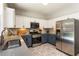 Modern eat-in kitchen with stainless steel appliances and light grey countertops at 169 Wallnut Hall Circle, Woodstock, GA 30189