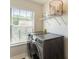 Laundry room equipped with washer, dryer, and natural light at 169 Wallnut Hall Circle, Woodstock, GA 30189