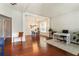 Spacious living room featuring hardwood floors, neutral walls, and a view of the dining area at 169 Wallnut Hall Circle, Woodstock, GA 30189