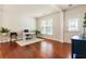 Well-lit living room featuring hardwood floors, neutral walls, and a view to the entryway at 169 Wallnut Hall Circle, Woodstock, GA 30189