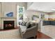 Living room view showcasing fireplace and a view of the kitchen at 169 Wallnut Hall Circle, Woodstock, GA 30189