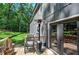 Inviting backyard patio with seating and a heater, overlooking a lush, wooded landscape at 194 Saddleridge Dr, Bremen, GA 30110