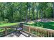 Inviting backyard deck with a rocking chair overlooking a lush, wooded landscape at 194 Saddleridge Dr, Bremen, GA 30110