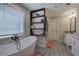 Bathroom showcasing a soaking tub, black and white tile floors, and custom storage at 194 Saddleridge Dr, Bremen, GA 30110