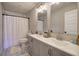 Updated bathroom with double sinks, shower, vanity, and decorative floor tiles at 194 Saddleridge Dr, Bremen, GA 30110