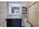 Bathroom featuring a sink with storage and a shower with decorative shelving at 194 Saddleridge Dr, Bremen, GA 30110