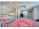 Spacious bedroom featuring a large rug, bed, study space, and ceiling fan at 194 Saddleridge Dr, Bremen, GA 30110