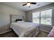 Cozy bedroom with a decorative bed frame, ceiling fan, and a sunny window at 194 Saddleridge Dr, Bremen, GA 30110