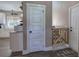 A bright entryway with white trim, doors, plank flooring, and a wooden gate at 194 Saddleridge Dr, Bremen, GA 30110