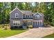 Two-story home features a well-manicured lawn, attached garage, front porch and lush, mature trees at 194 Saddleridge Dr, Bremen, GA 30110