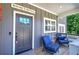 The home's welcoming front porch features comfortable seating for relaxing outdoor visits at 194 Saddleridge Dr, Bremen, GA 30110