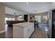 Kitchen area with white cabinets, marble countertop island, and a view into the living room at 194 Saddleridge Dr, Bremen, GA 30110