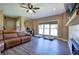 Spacious living room features a large window, wood-look floors and comfortable leather sofa at 194 Saddleridge Dr, Bremen, GA 30110