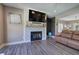 Living room with a decorative fireplace, wood-look floors and comfortable seating arrangement at 194 Saddleridge Dr, Bremen, GA 30110