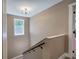 Carpeted stairwell with neutral paint, black railing, and white window frame at 194 Saddleridge Dr, Bremen, GA 30110