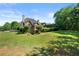 The yard has mature trees, landscaping, and a screened-in porch on the house at 4440 Green Summers Dr, Cumming, GA 30028