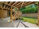 Backyard under the deck with concrete patio, stairs to the upper deck, and green lawn at 4440 Green Summers Dr, Cumming, GA 30028