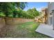 A spacious yard with wood retaining wall, a deck, and an entrance to the basement at 4440 Green Summers Dr, Cumming, GA 30028
