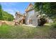 Grassy backyard features a screened-in porch, deck, mature trees, and lush landscaping at 4440 Green Summers Dr, Cumming, GA 30028