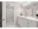 Bathroom featuring a white vanity with drawers, white tile floor and tub with shower at 4440 Green Summers Dr, Cumming, GA 30028