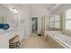Bathroom with tiled floor, glass enclosed shower, soaking tub, and double sink vanity at 4440 Green Summers Dr, Cumming, GA 30028