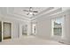 Bright bedroom with tray ceilings, carpet floors and ensuite bathroom with double doors at 4440 Green Summers Dr, Cumming, GA 30028