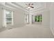 Spacious bedroom with a tray ceiling, carpet floors, and large windows allowing natural light at 4440 Green Summers Dr, Cumming, GA 30028